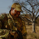 Oz (Green Beret) sharing a moment with an opharned rhino calf.