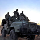 Biggs (Navy SEAL fmr.), Oz (Green Beret), Saw (Navy SEAL fmr.), Rob (Navy SEAL ret.) traveling on Reva vehicle on patrol.