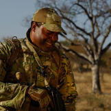 Oz (Green Beret) sharing a moment with an opharned rhino calf.
