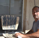 Ed Rosenberg studies the furniture left outside this home before he places a bid.