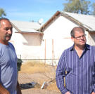 Buyers Ed Rosenberg and Doug Hopkins examine a home prior to auction.