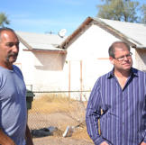 Buyers Ed Rosenberg and Doug Hopkins examine a home prior to auction.