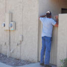 Ed Rosenberg peeks over a wall before placing his bid.