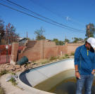 John Ray assesses the condition of the pool and back yard at this property in Phoenix.