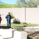 Doug Hopkins and Shari Pozniak inspect the trampoline pit in the back yard of this property.