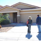 Doug Hopkins and Shari Pozniak admire the curb appeal of this auction home.