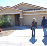 Doug Hopkins and Shari Pozniak admire the curb appeal of this auction home.