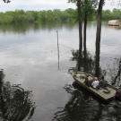 When living in the bayou, boat transportation is crucial. Here, a realtor takes potential homebuyers from one house to the next by water.