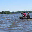 A Buying the Bayou realtor takes potential homebuyers to see a property by boat.