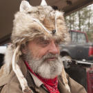 Trapper wears a fur hat.