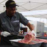 Michael Character cuts meat.