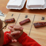 Tuffy inspects a set of ribs before judging them.